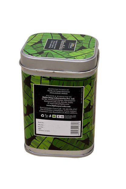 Organic henna powder tin with green leaf pattern and white barcode label