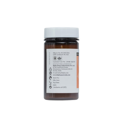 Herbal supplement bottle with white cap and manufacturing details label