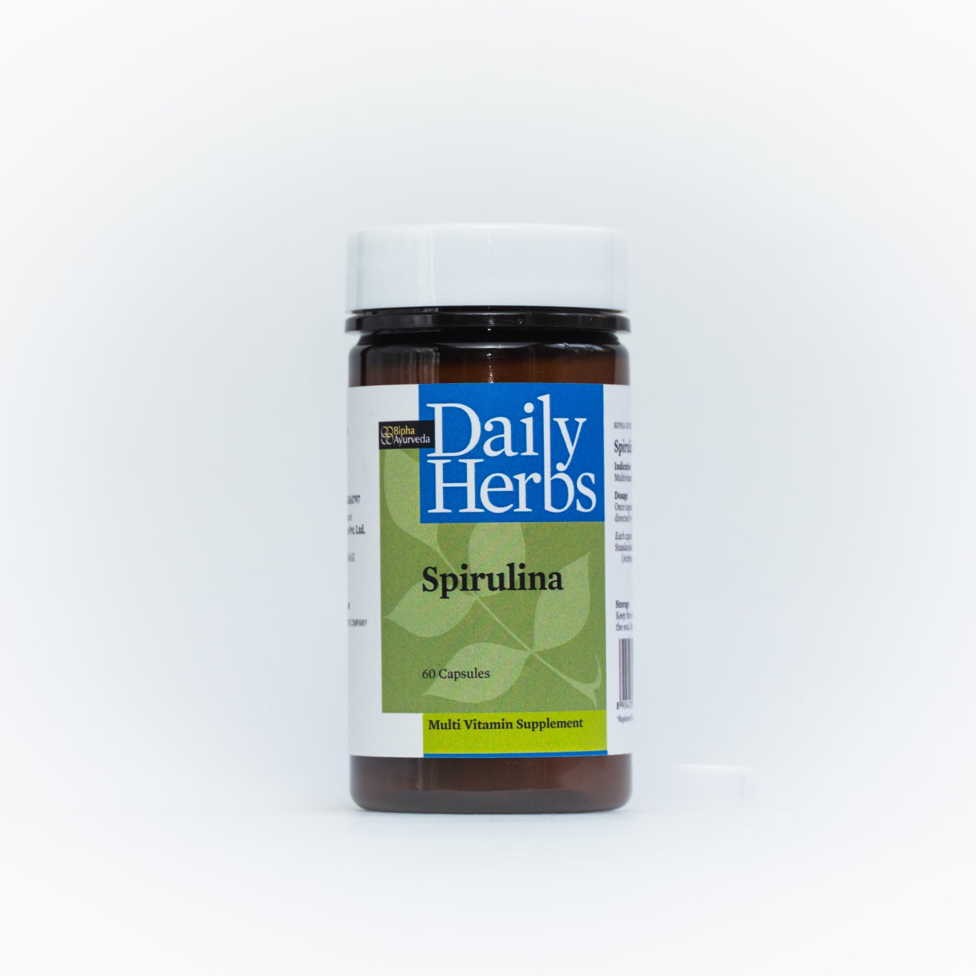 Spirulina supplement bottle with Daily Herbs label, black cap and green front panel.