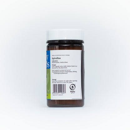 Spirulina supplement bottle with Daily Herbs back label, black cap and brown base.