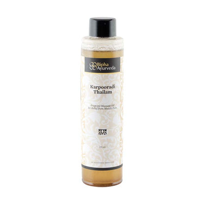 Ayurvedic oil bottle with black cap and gold-trimmed white label on a plain background.