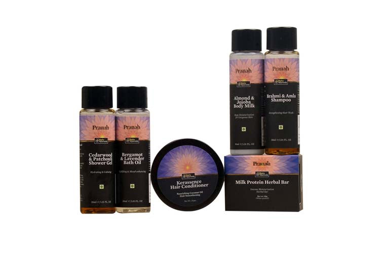 Luxury spa indulgence gift set with bottles, hair conditioner balm, body milk, and herbal bar