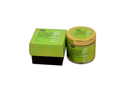 Skin nourishing cream jar with gold lid beside matching green box