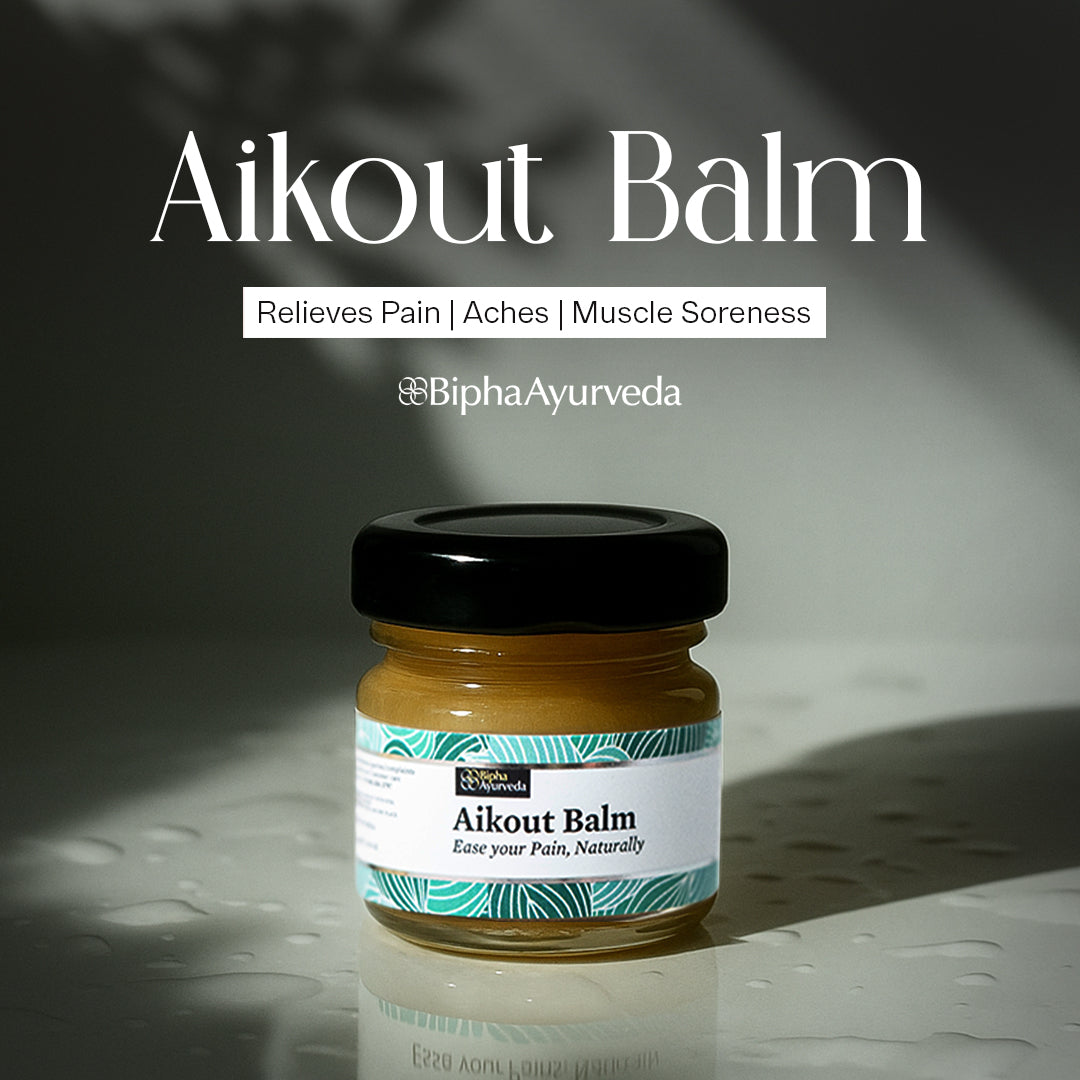 Herbal pain relief balm jar with black lid and teal label on a glossy surface