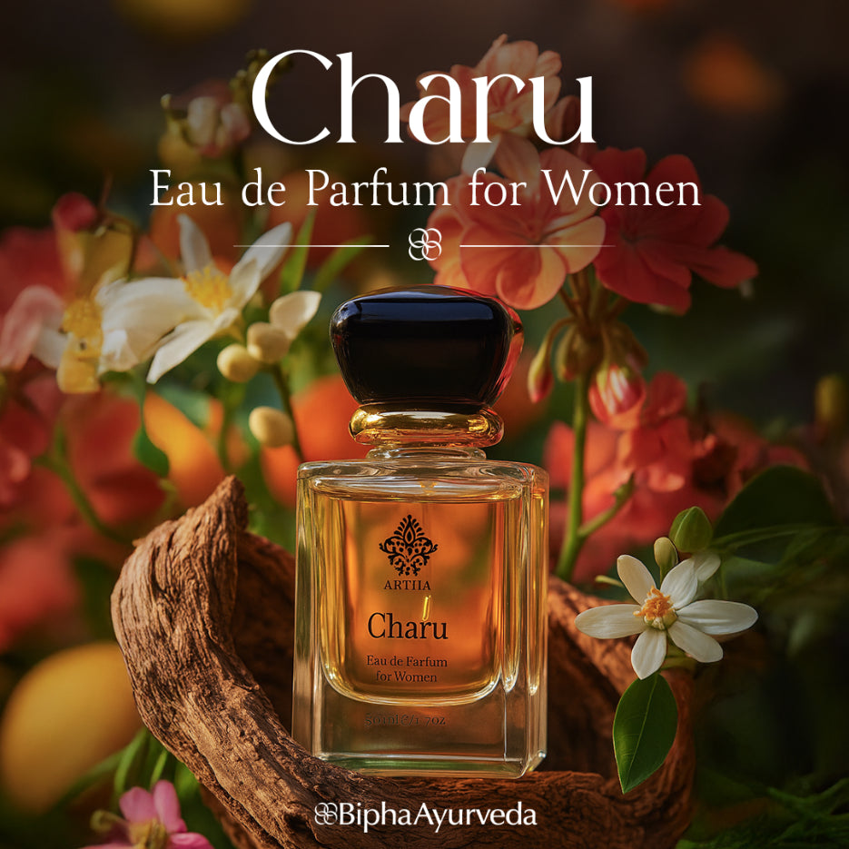 Eau de parfum bottle with dark cap and amber liquid, with flowers around