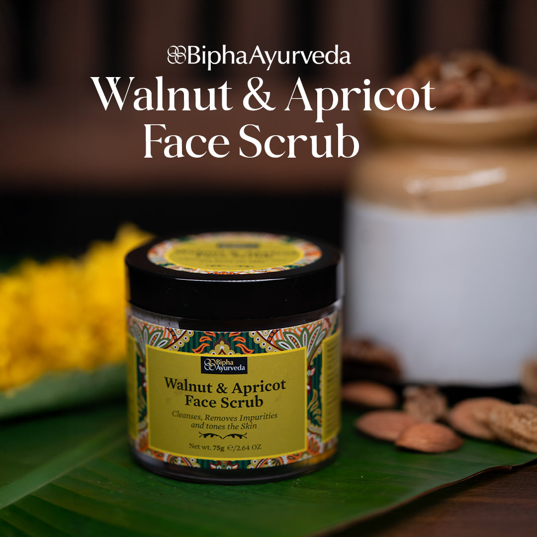 Face scrub jar with black lid and yellow front label on a surface.